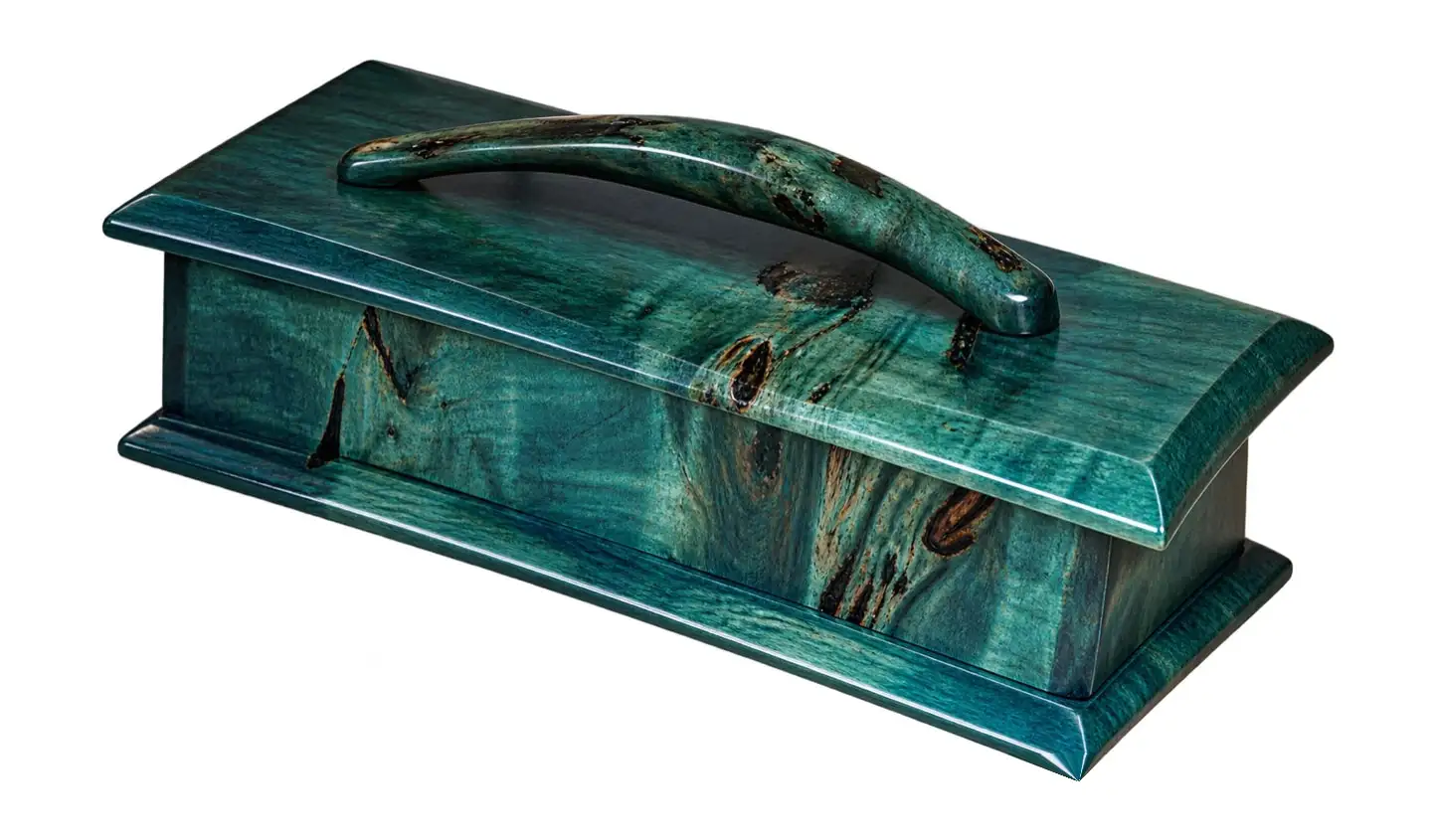 Thalassa. A lidded box in teal-dyed burl with an arched handle.