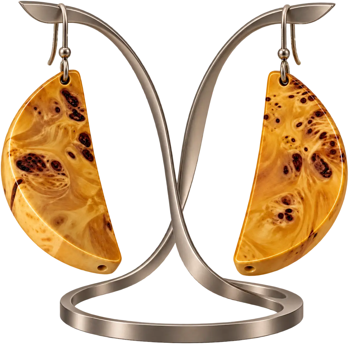 Ambra. Half-moons in golden burl, marked with dark eyes.
