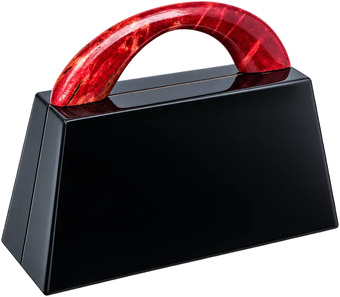 Kleinood. A high-gloss black body with sloping sides, carried by an arched handle in red burl. It opens along a bronze-toned frame to a violet lining.